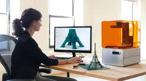 Woman using a 3D modeling program on a computer.
