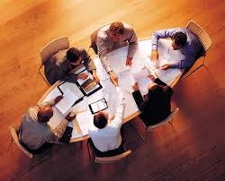 people at a conference table in a meeting